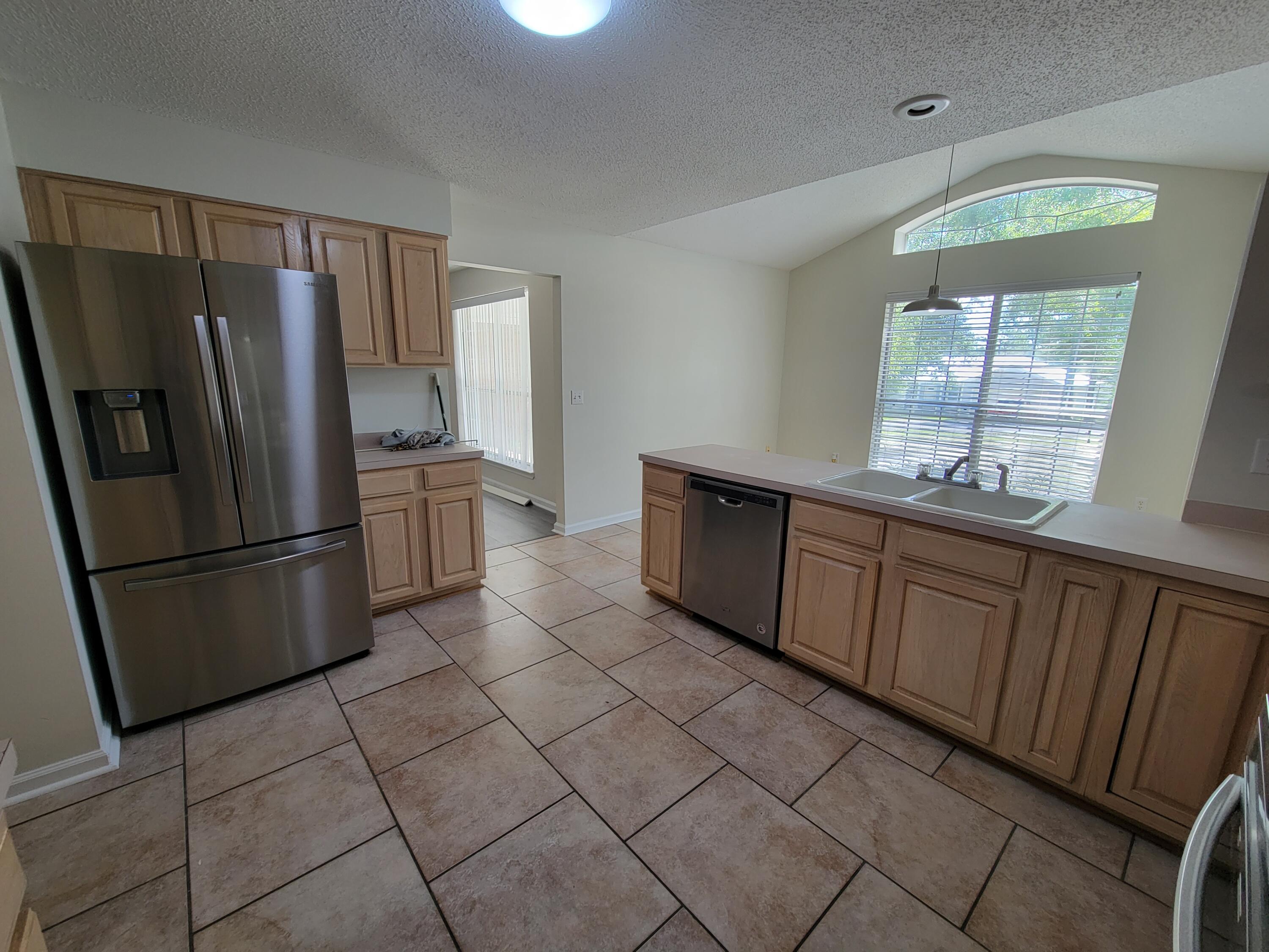45 Hidden Lakes Trail DeFuniak Springs, FL 32433 - Photo 8 of 39 a kitchen with stainless steel appliances granite countertop a refrigerator sink and cabinets
