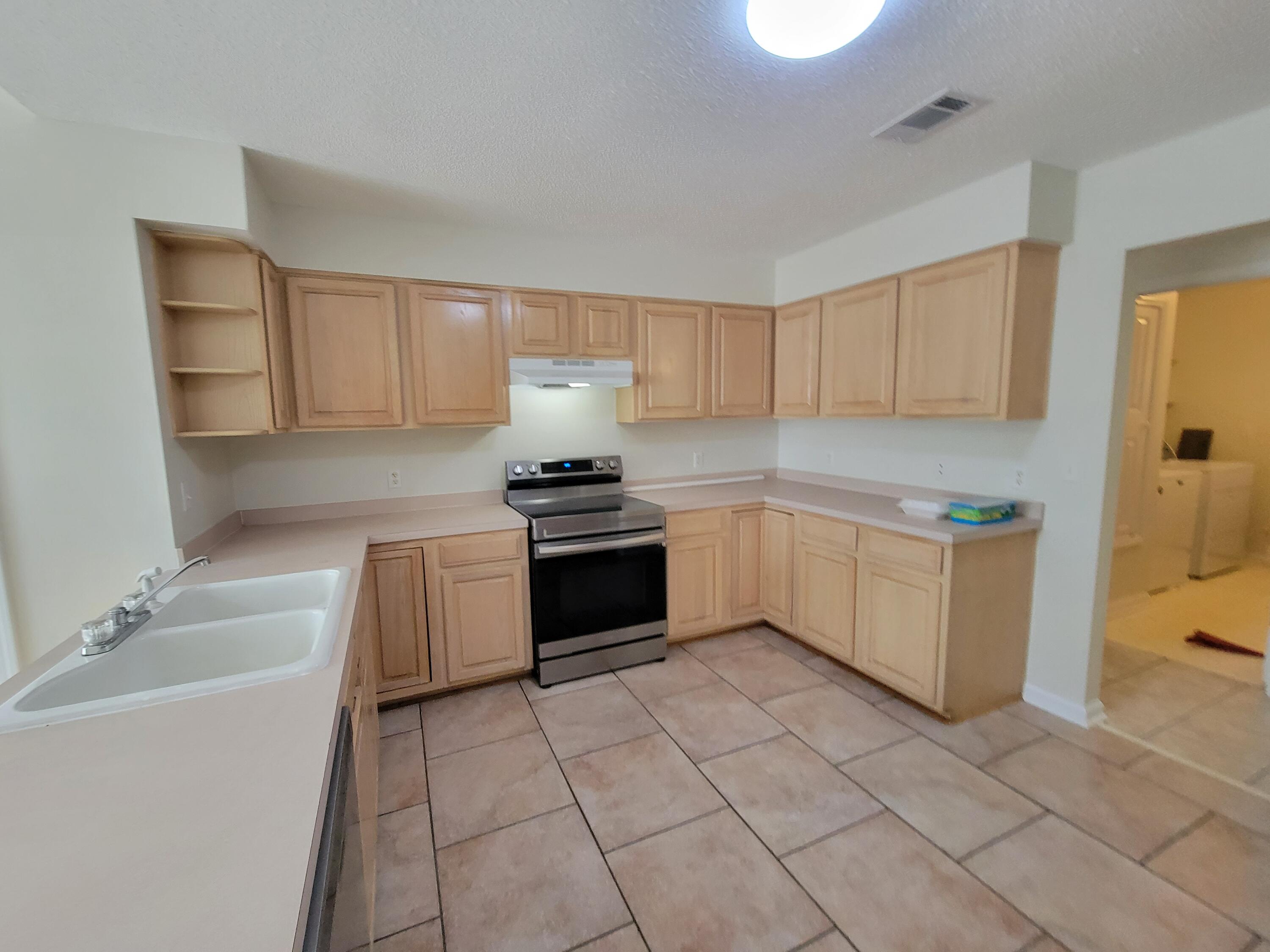 45 Hidden Lakes Trail DeFuniak Springs, FL 32433 - Photo 9 of 39 a kitchen with a stove top oven and cabinets