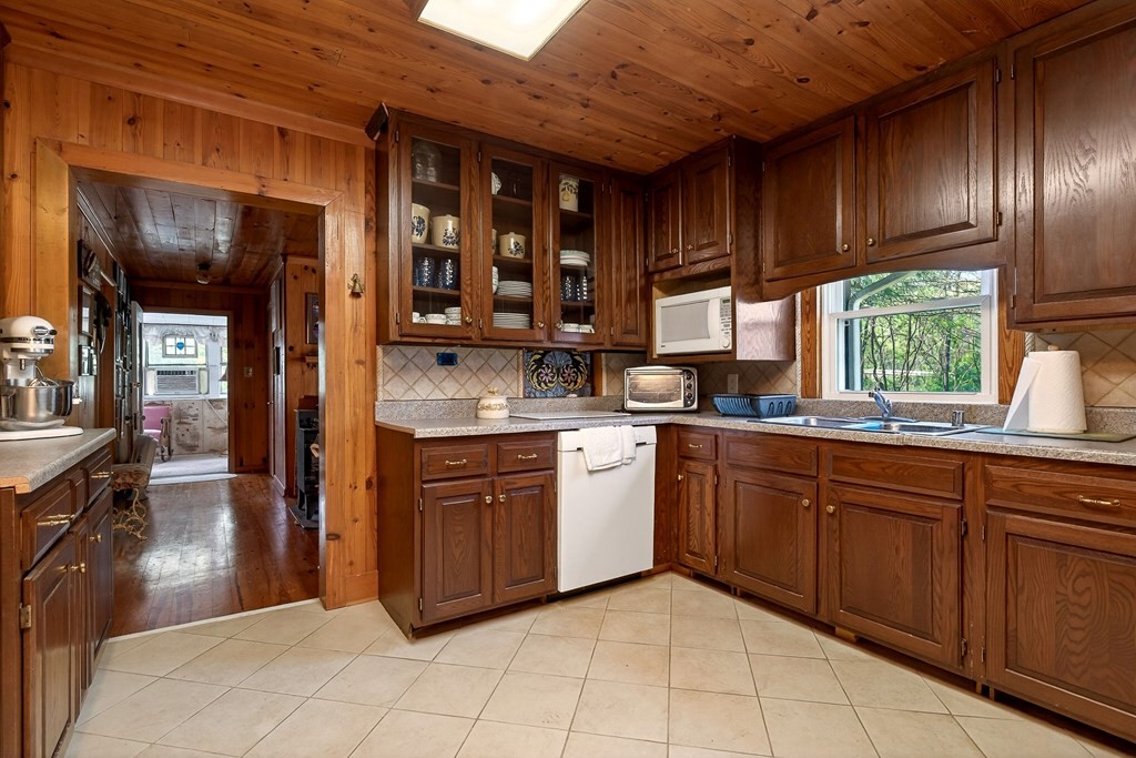 1932 Holly Creek Road Celina, TN 38551 - Photo 5 of 31 a kitchen with stainless steel appliances granite countertop wooden cabinets a sink and a stove