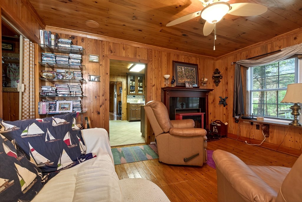 1932 Holly Creek Road Celina, TN 38551 - Photo 10 of 31 a living room with furniture a fireplace and a flat screen tv