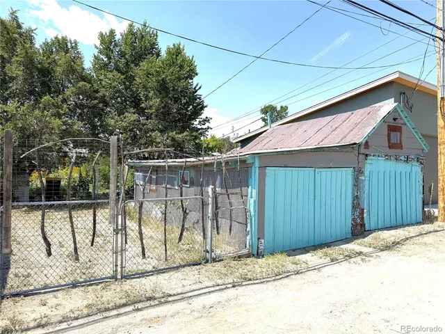 a view of a house with a wooden fence