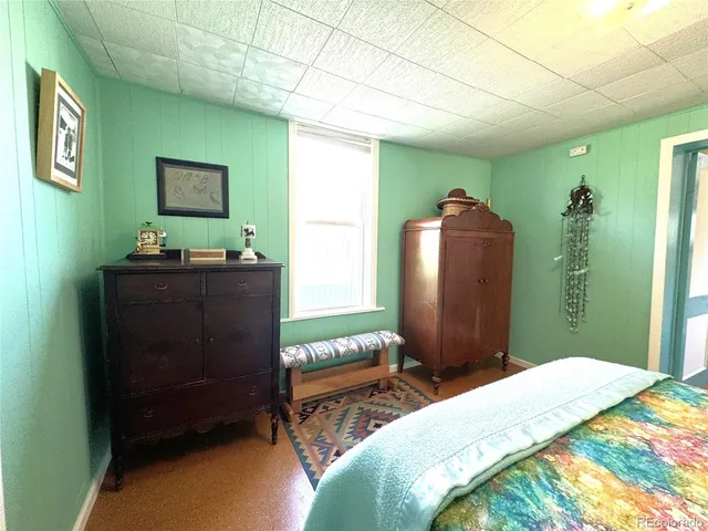 a bedroom with a bed and a mirror