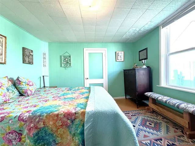 a bedroom with a bed dresser and a window