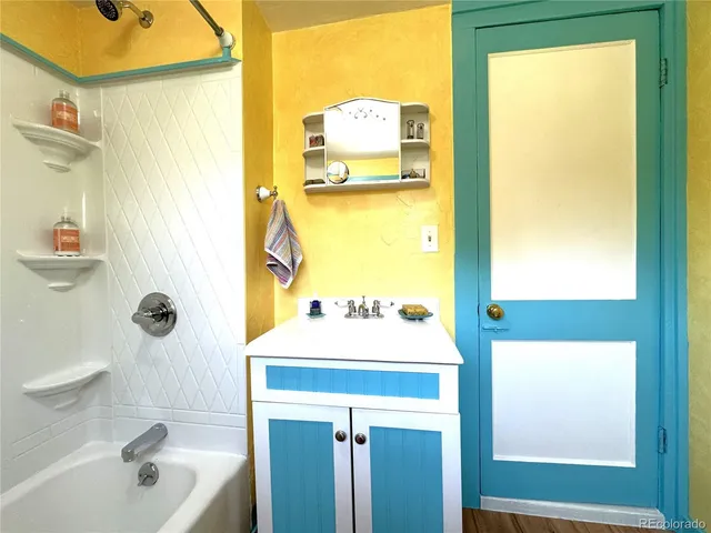 a bathroom with a sink a mirror and a bathtub