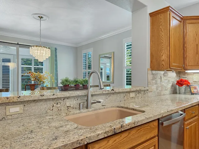 a kitchen with granite countertop a sink and a wooden floor