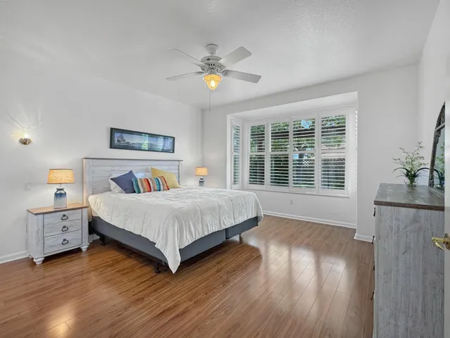 a spacious bedroom with a large bed and a chandelier