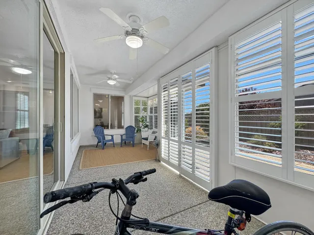 a view of a livingroom with workspace and a window