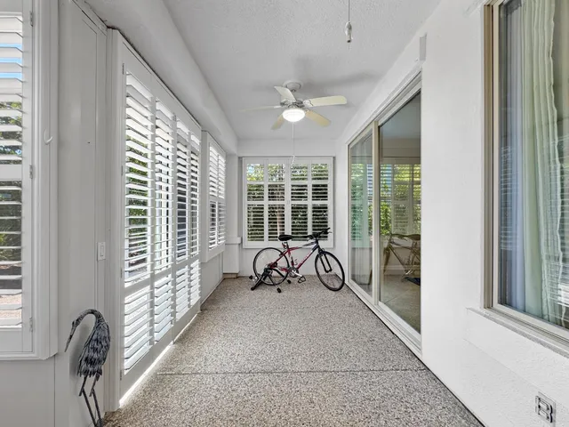 a view of a large room with balcony and furniture
