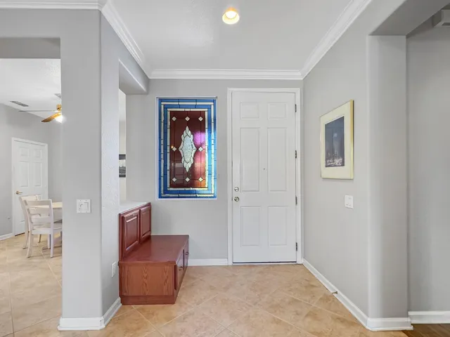 a living room with furniture and a painting on the wall