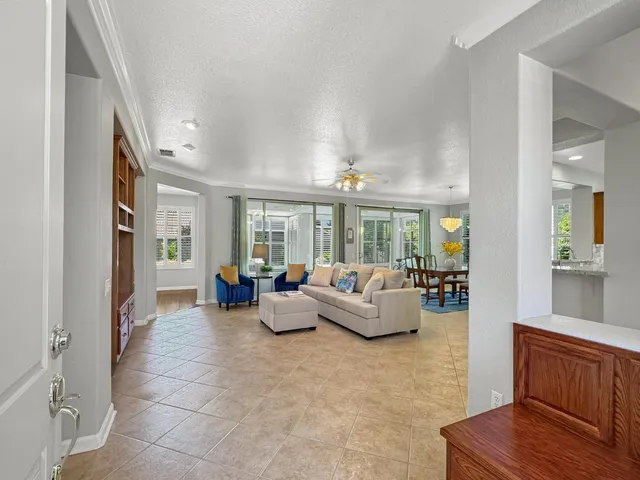 a living room with furniture and large windows