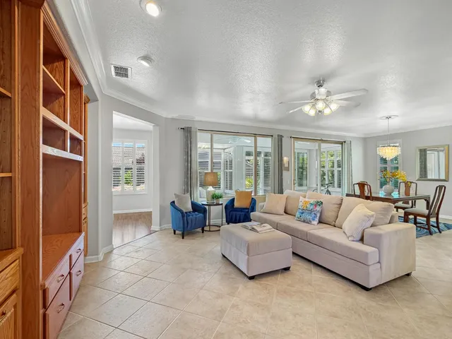 a living room with furniture and large windows