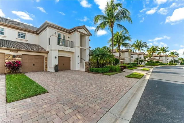 a house with a yard and a car park in front of it