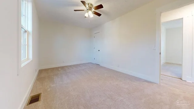 a view of an empty room with a window