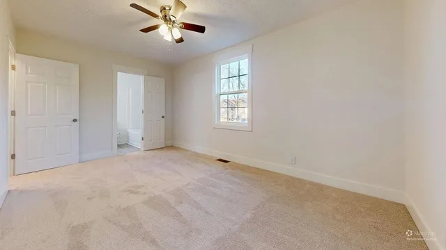 a view of a house with a yard covered in snow