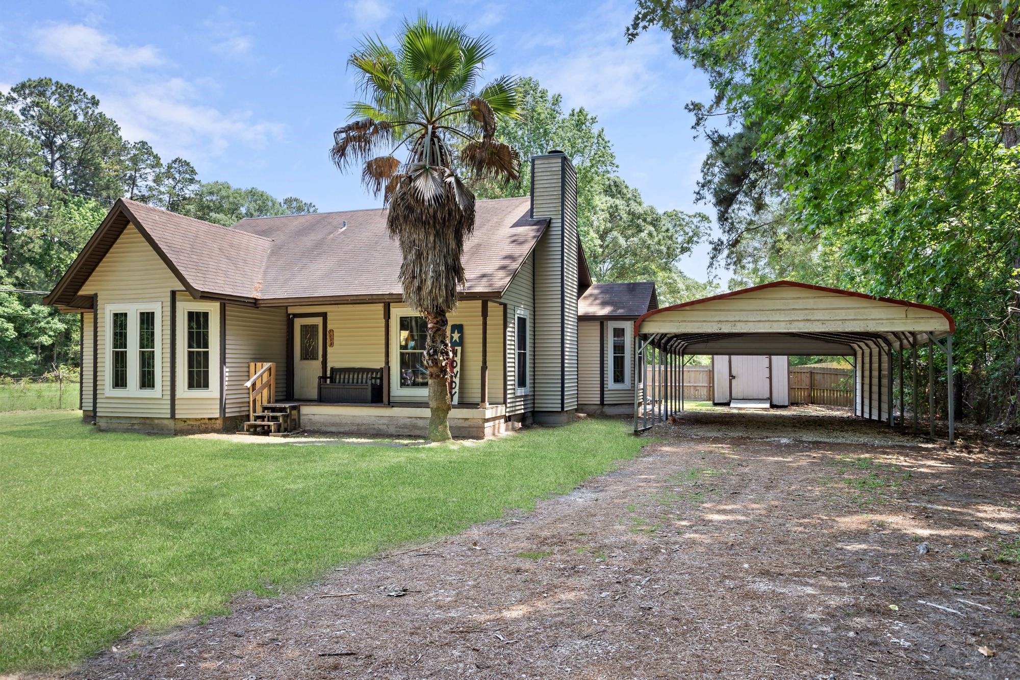 9994 Ruby Lane Silsbee, TX 77656 - Photo 2 of 17 a front view of a house with a garden and trees