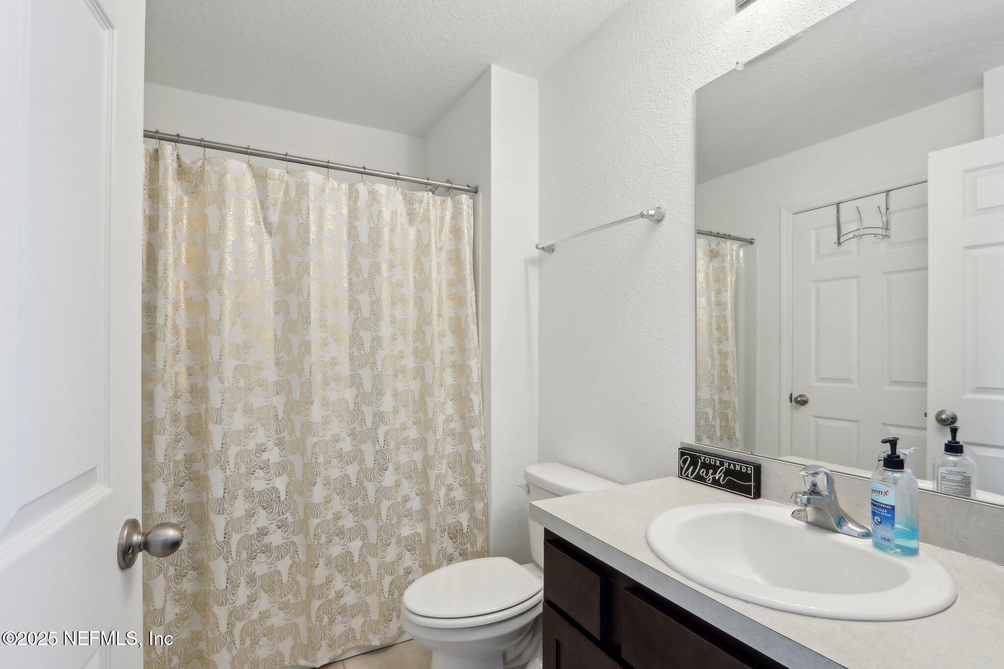 4932 Earthshine Road Jacksonville, FL 32256 - Photo 17 of 28 a bathroom with a sink toilet and shower