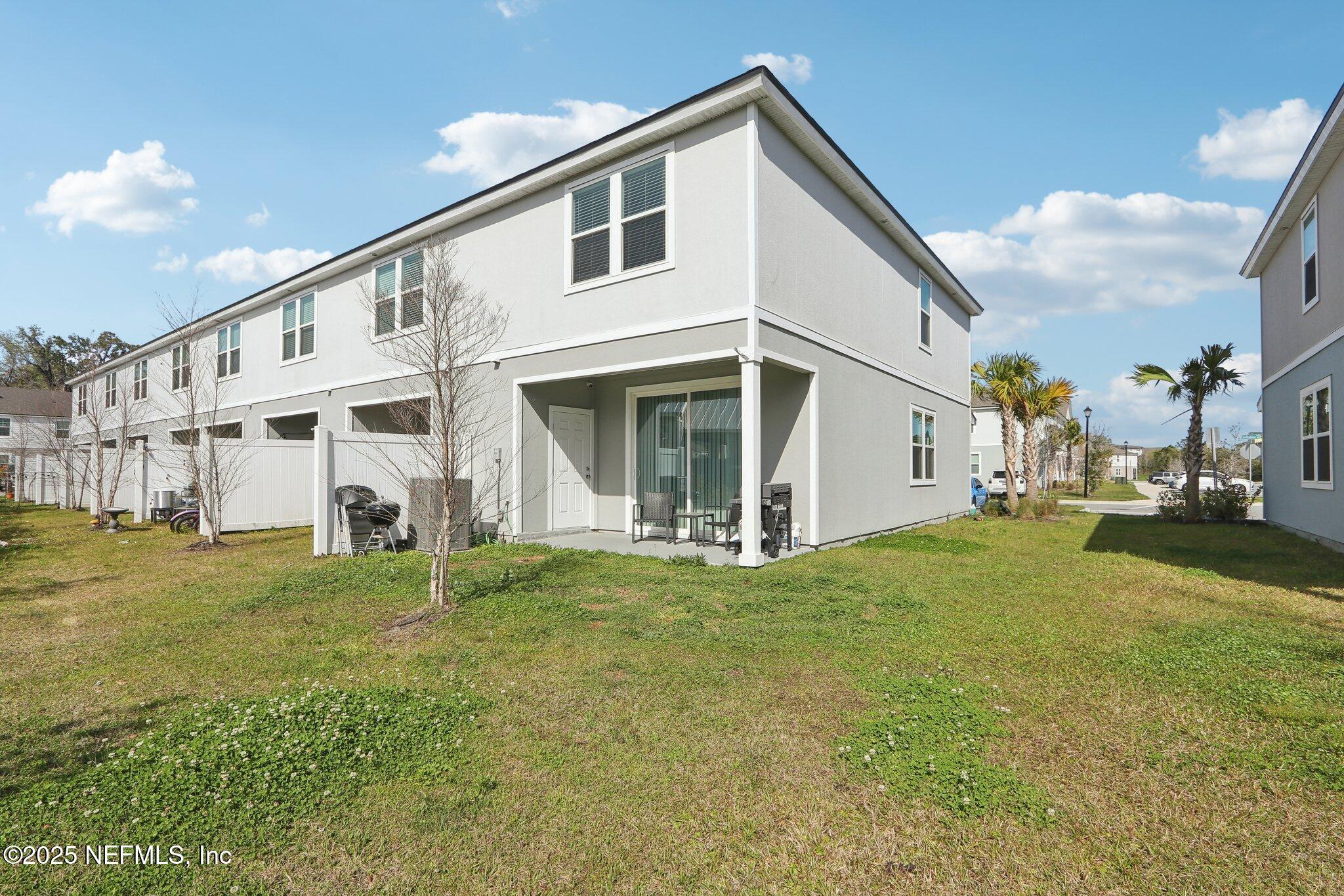 4932 Earthshine Road Jacksonville, FL 32256 - Photo 20 of 28 a view of a house with a yard