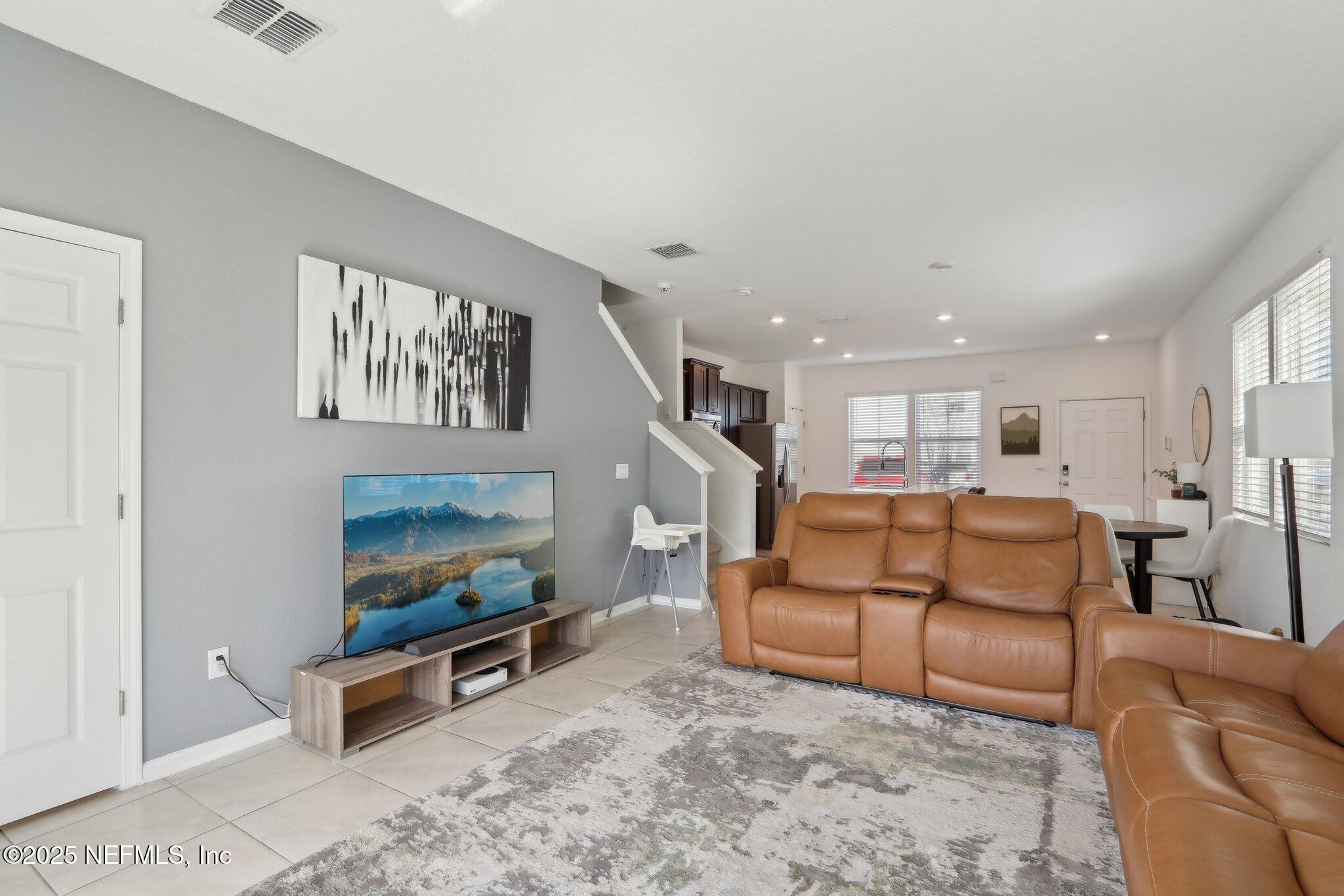 4932 Earthshine Road Jacksonville, FL 32256 - Photo 2 of 28 a living room with furniture and a fireplace
