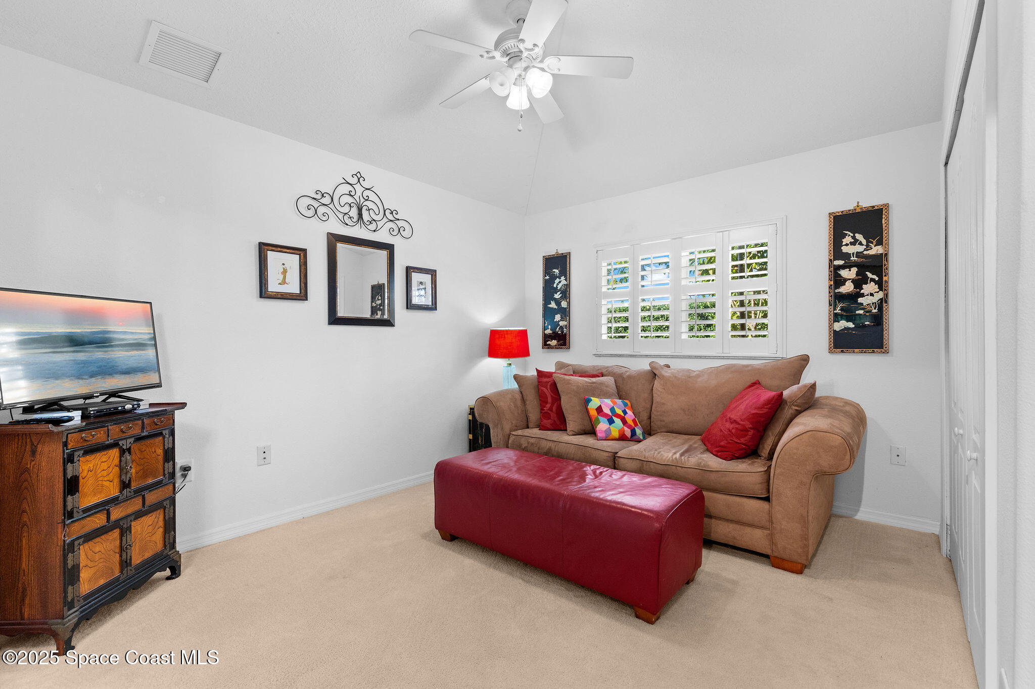 7248 Broderick Drive Melbourne, FL 32940 - Photo 17 of 51 a living room with furniture a flat screen tv and a window