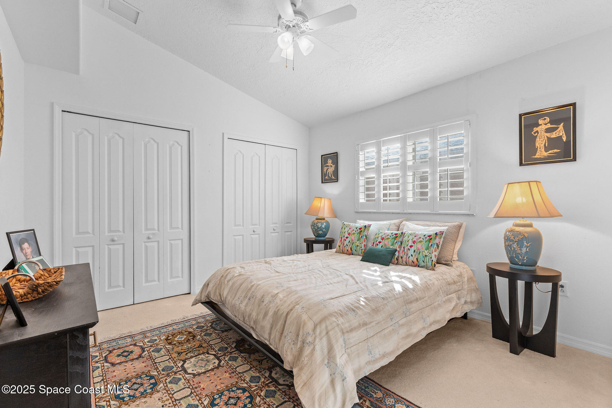 7248 Broderick Drive Melbourne, FL 32940 - Photo 21 of 51 a bedroom with a bed and a chandelier