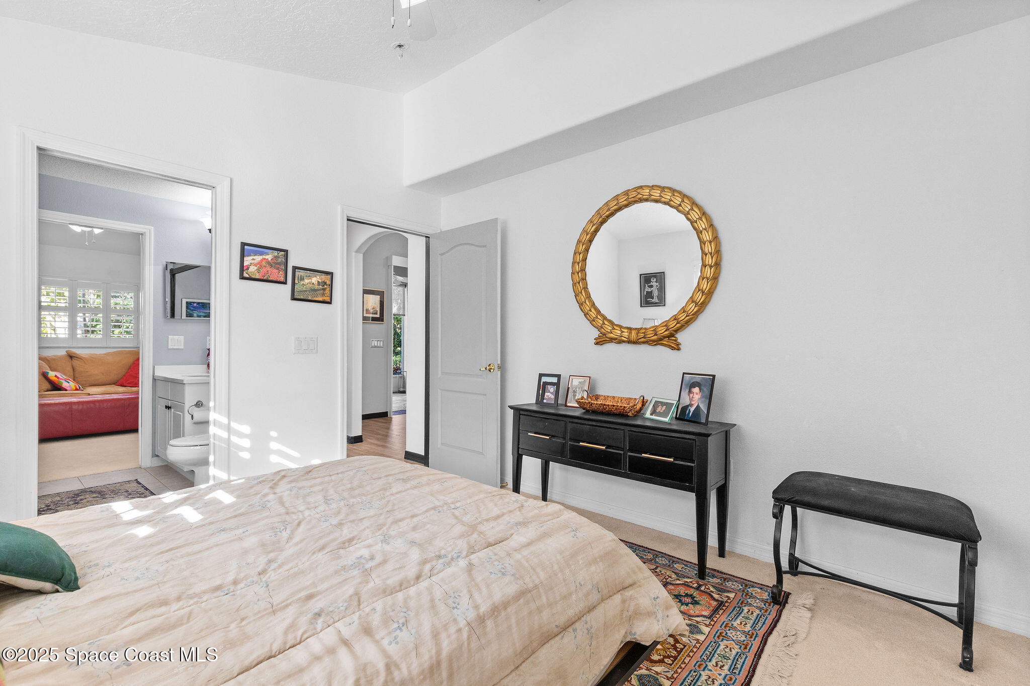 7248 Broderick Drive Melbourne, FL 32940 - Photo 22 of 51 a bedroom with a bed and a potted plant