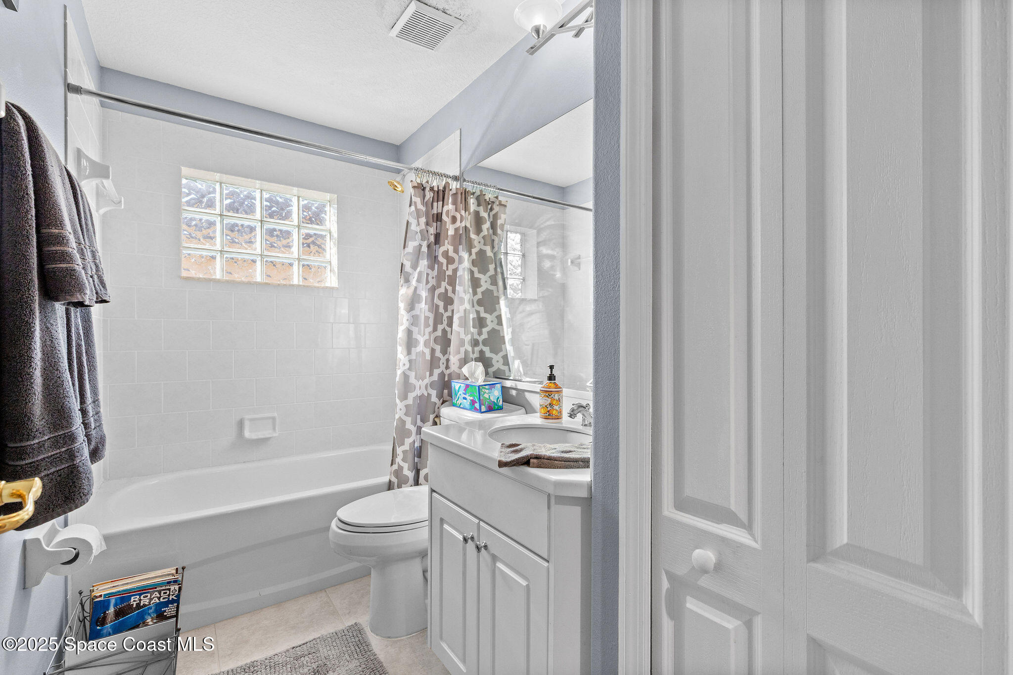 7248 Broderick Drive Melbourne, FL 32940 - Photo 25 of 51 a bathroom with a sink a toilet and a shower curtain