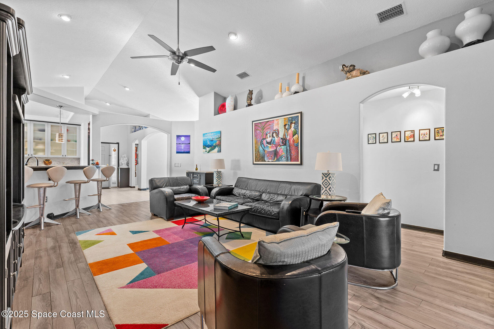 7248 Broderick Drive Melbourne, FL 32940 - Photo 26 of 51 a living room with lots of furniture and kitchen view
