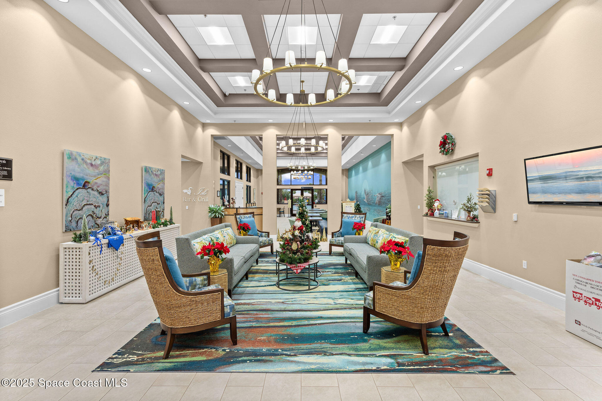 7248 Broderick Drive Melbourne, FL 32940 - Photo 42 of 51 a living room with furniture a chandelier and a rug