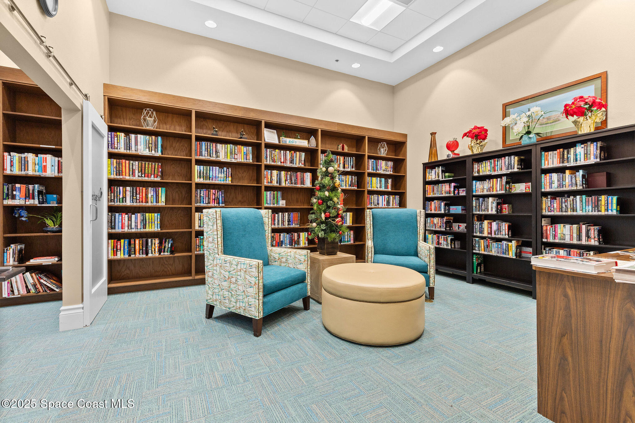 7248 Broderick Drive Melbourne, FL 32940 - Photo 45 of 51 a living room with furniture and a book shelf