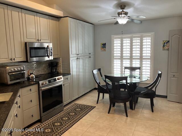 7248 Broderick Drive Melbourne, FL 32940 - Photo 8 of 51 a kitchen with stainless steel appliances granite countertop a stove a refrigerator a microwave a dining table and chairs