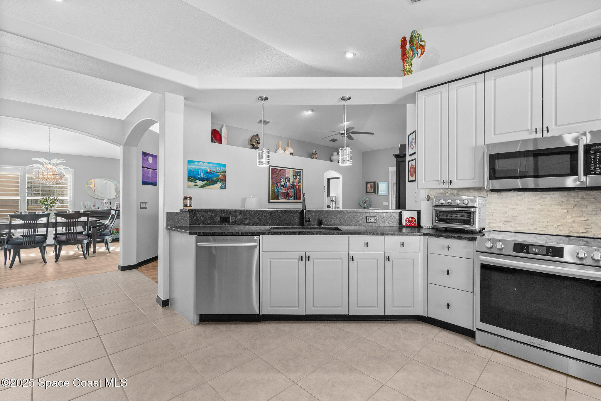 7248 Broderick Drive Melbourne, FL 32940 - Photo 10 of 51 a kitchen with stainless steel appliances granite countertop a sink and cabinets