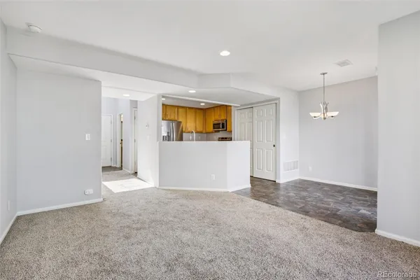 an empty room with a bathroom and a sink