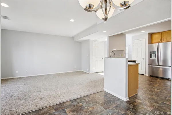 a view of a kitchen with a sink and refrigerator