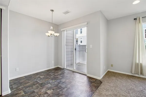 an empty room with windows and entrance