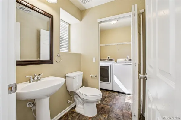 a bathroom with a sink toilet and mirror