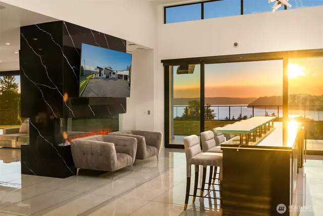 a living room with furniture and a floor to ceiling window