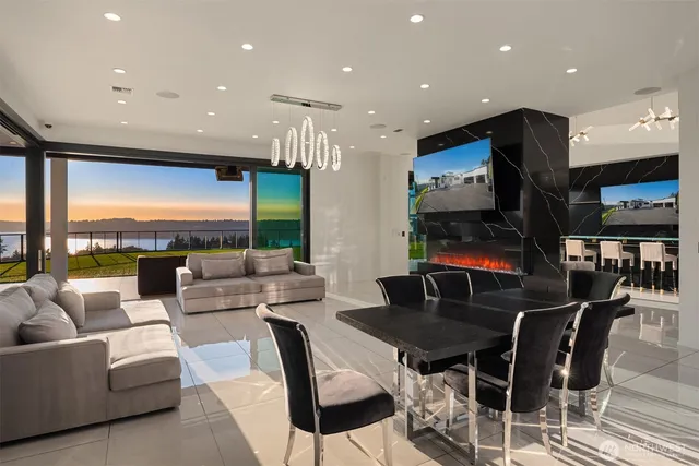 a living room with furniture kitchen view and a large window