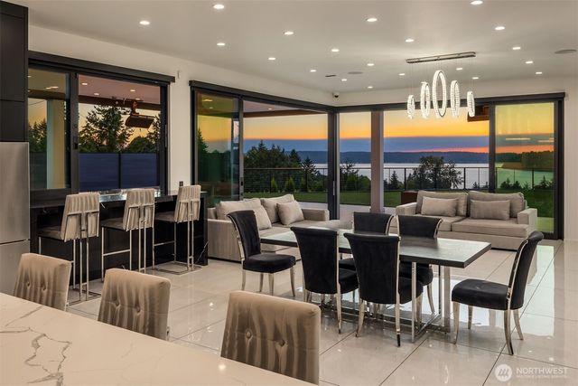 a living room with furniture large window and a table