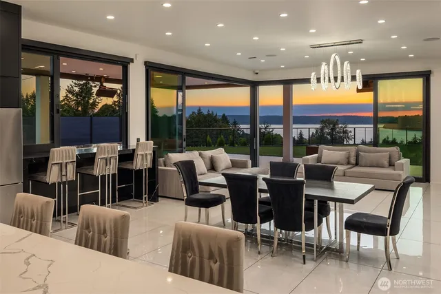 a living room with furniture large window and a table