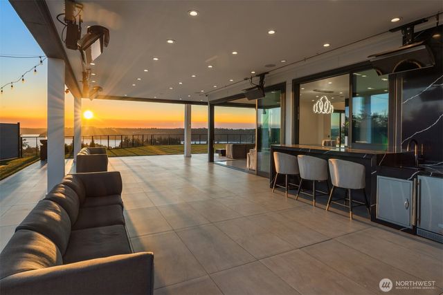 a living room with furniture and a floor to ceiling window