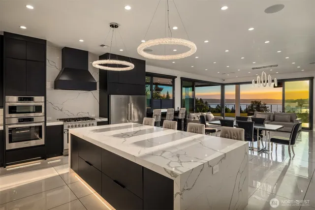 a kitchen with a stove a refrigerator and a dining table