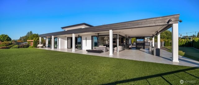 a view of a house with backyard porch and sitting area