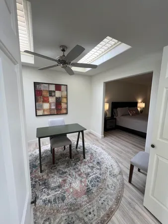 a view of a livingroom with furniture and a workspace