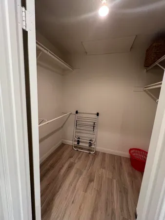 a view of a room with wooden floor