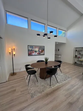 a living room with furniture a table and wooden floor