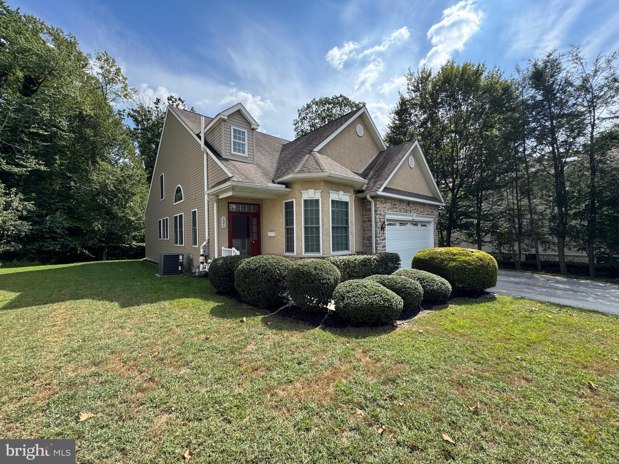 a view of a house with a garden and yard