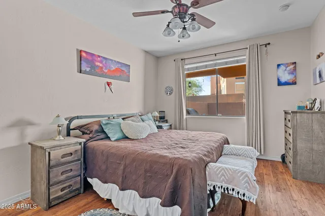 a bedroom with a bed and wooden floor