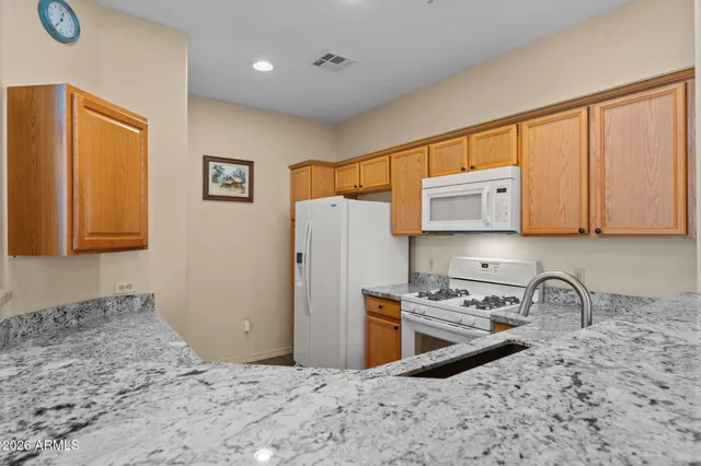 a kitchen with granite countertop a sink and a window