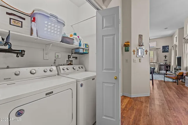 a view of washer and dryer with kitchen in the background
