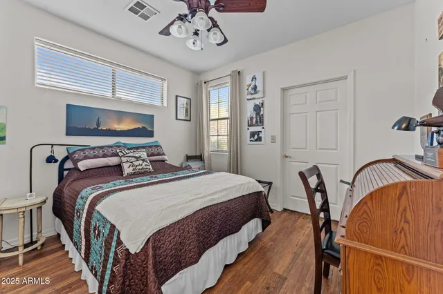 a bedroom with a bed and a chandelier